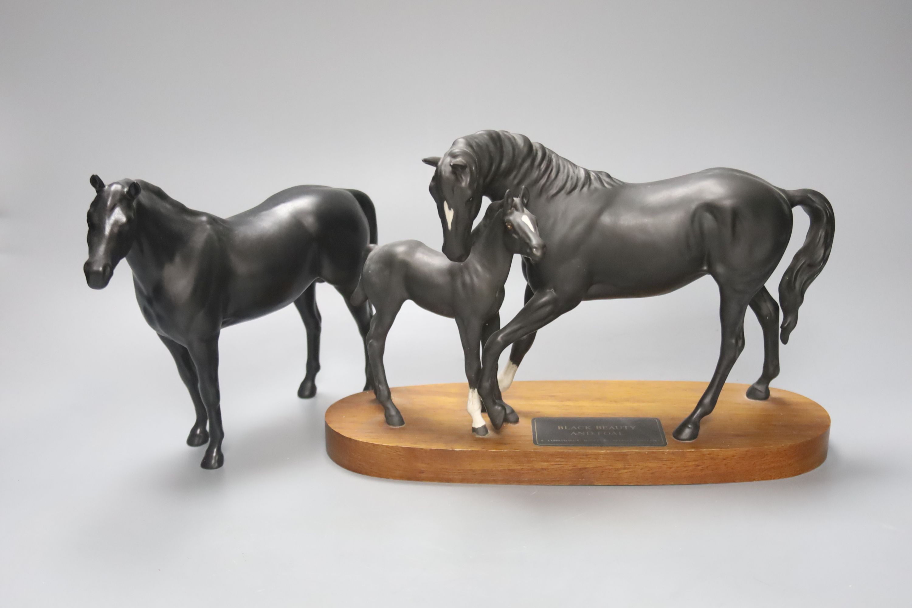 A Beswick Black Beauty and Foal, and three other Beswick black horses